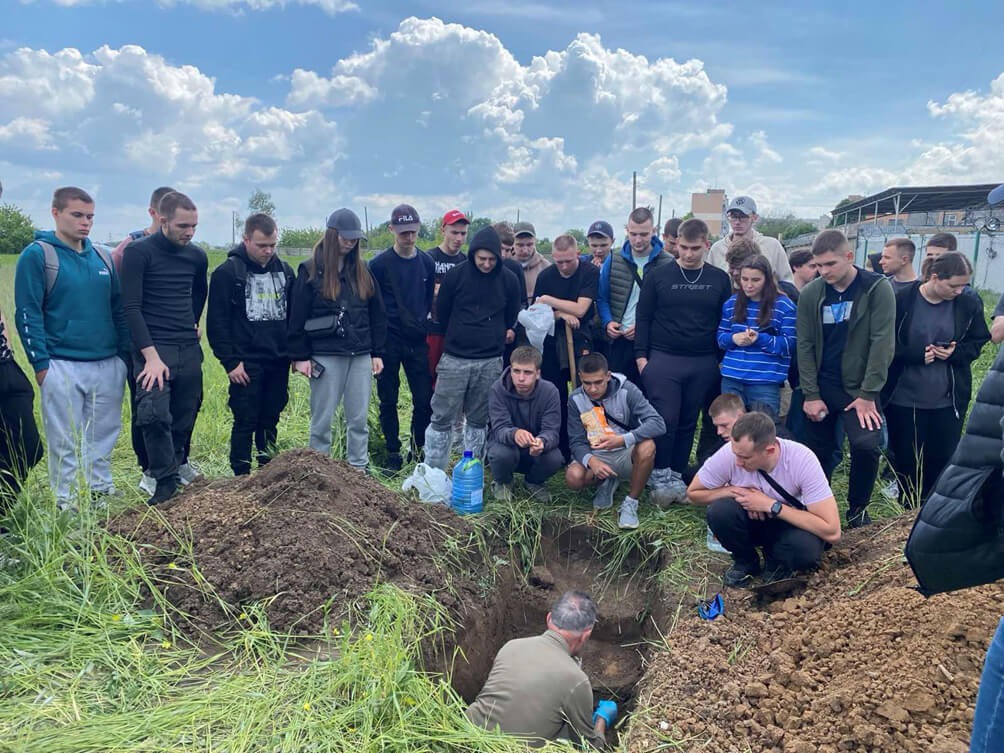 Professor Dmytruk and his students digging a pit to assess the soil properties and determine soil identification using LandPKS Soil ID in Ukraine.